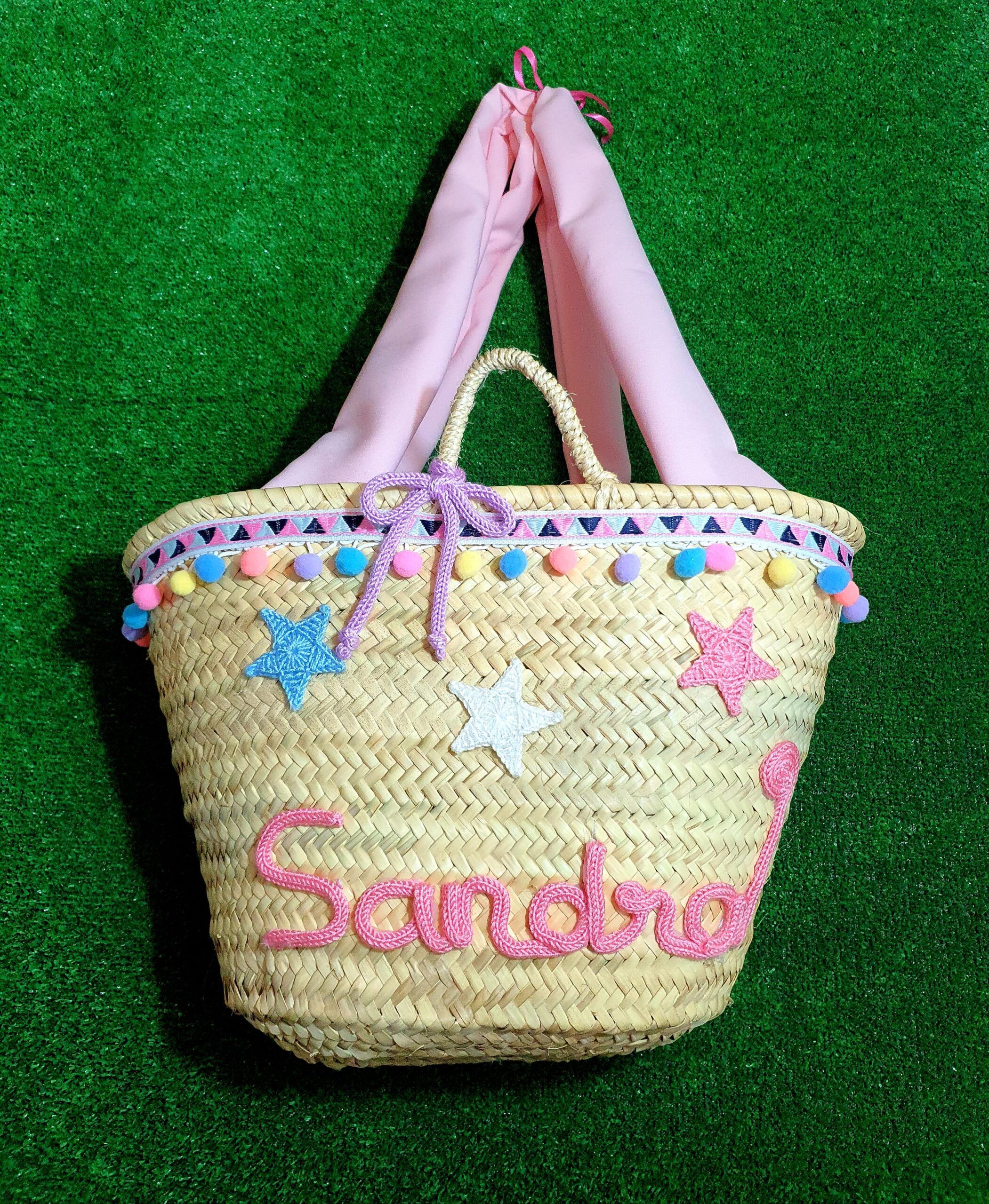 Cesta mediana interior forrado y asas de tela con cordoncillo de triángulos de ponpones de colores y estrellitas con nombre